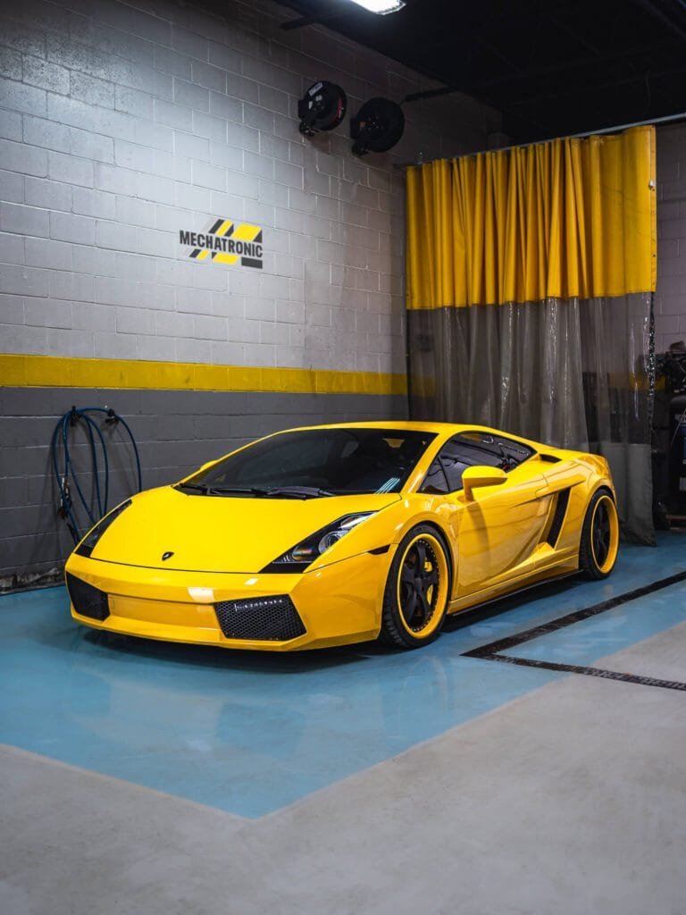 Dark Yellow Lamrboghini Gallardo Inside of Shop